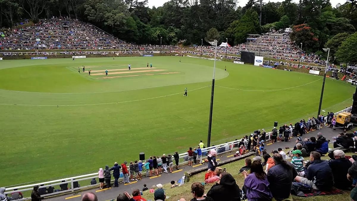 Spectators watch as a domestic cricket match is played at the Pukekura Park stadium in New Plymouth.
