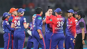 Kapp, centre, celebrates the wicket of Sabbhineni Meghana with her teammates on Saturday.