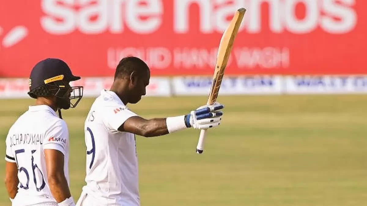 Angelo Matthews raises his bat after reaching his century against NZ on Day 4 on Sunday.
