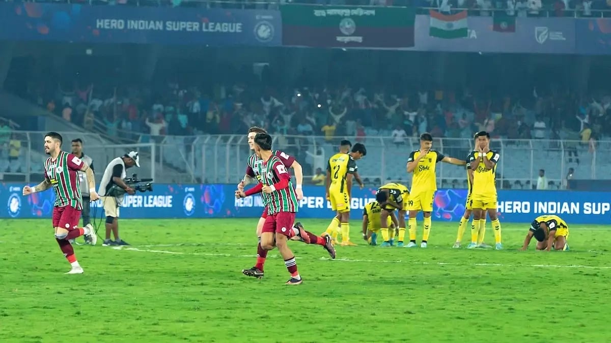 ATKMB celebrate as HFC players look on in Kolkata on Monday.