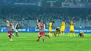 ATKMB celebrate as HFC players look on in Kolkata on Monday.