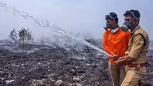 Fire and safety department officials at the Brahmapuram waste treatment plant in Kerala
