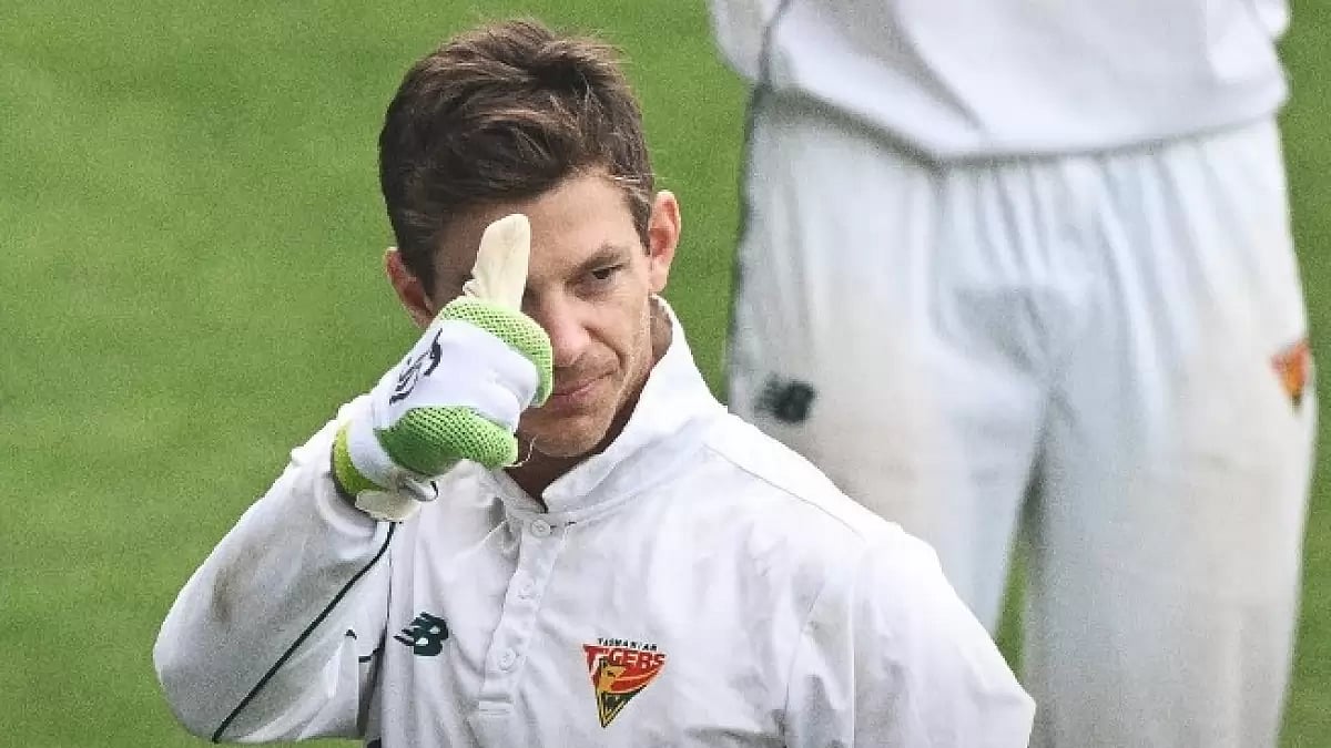 Paine gestures to his teammates after playing his last Sheffield Shield match on Friday.