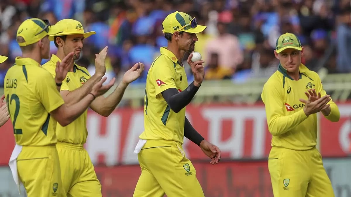 Mitchell Starc is acknowledged by his teammates as he walks off the field after the Indian innings.
