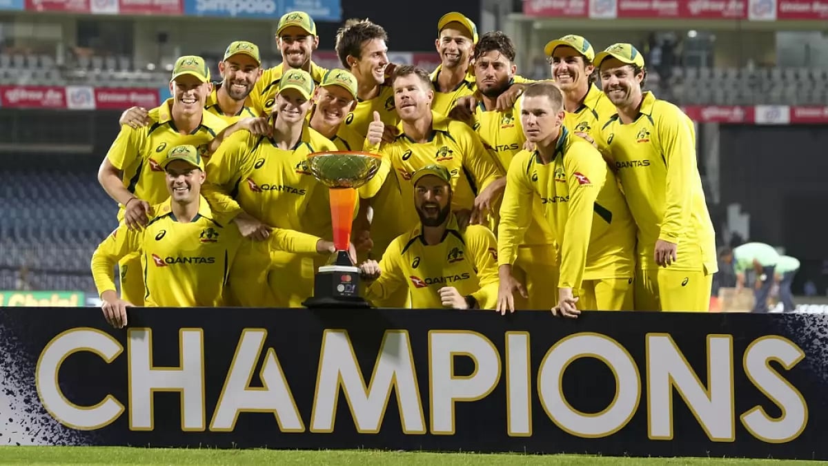 Australia players celebrate with the winner's trophy after their win over India in Chennai on Sunday
