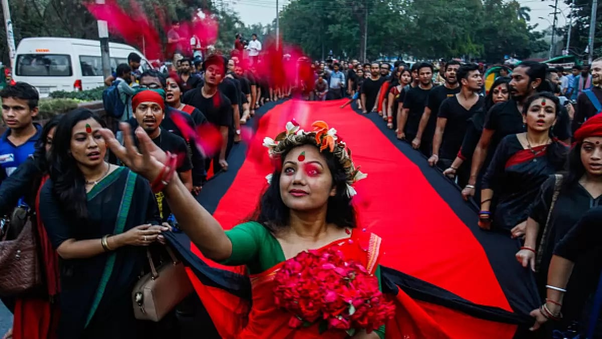 Bangladeshi artist and social activist throws flowers as they participates in a rally in Dhaka, Bangladesh, March 25, 2018. The rally was organized in remembrance of those who were killed on March 25, 1971, a day ahead of the country's declaration of independence from Pakistan