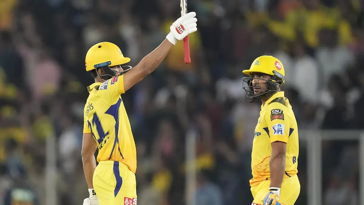 Ruturaj Gaikwad raises his bat after reaching his half-century against GT on Friday.