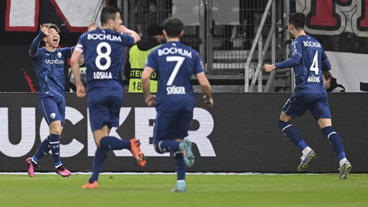 Asano, left, celebrates with his team-mates after scoring Bochum's only goal on Friday.