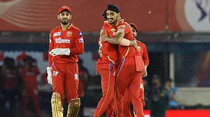 Arshdeep celebrates the wicket of Nitish Rana with his team-mates in Mohali on Saturday.
