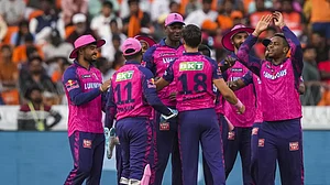 Rajasthan Royals players celebrate the wicket of Rahul Tripathi on Sunday.