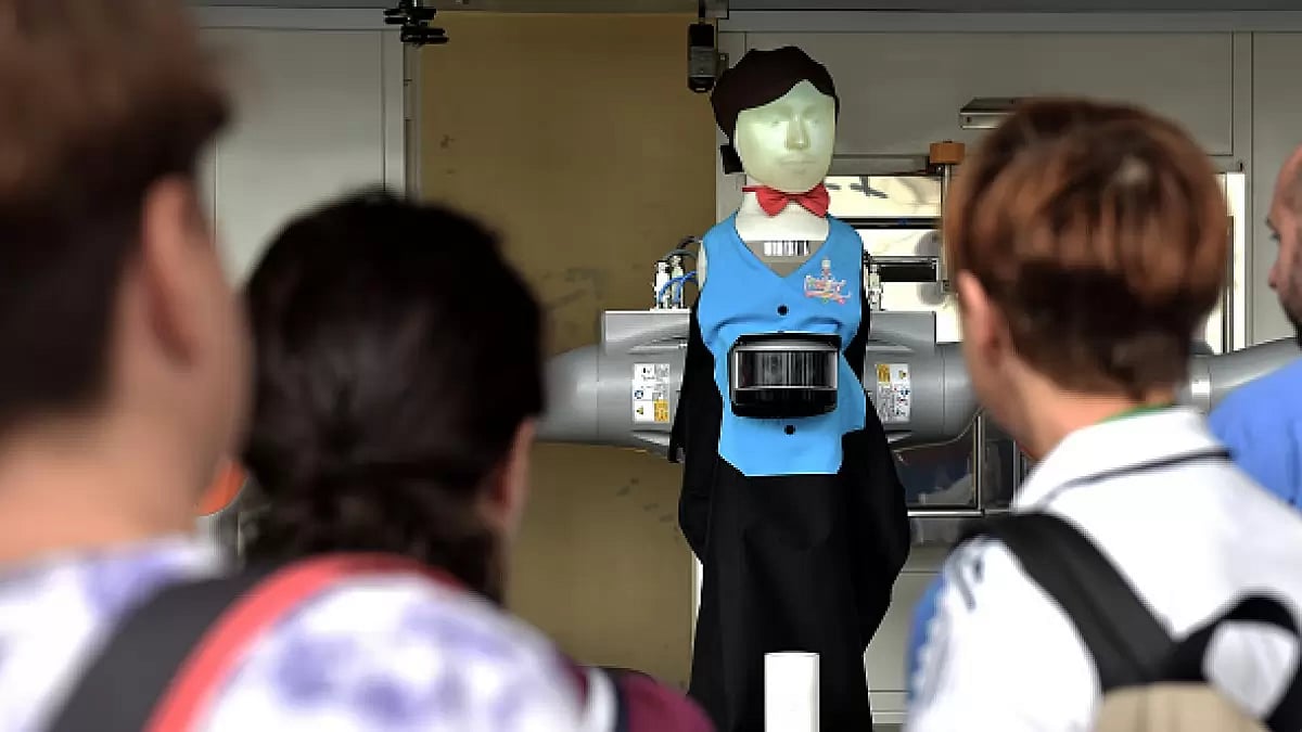 Will Artificial Intelligence replace humans in jobs? A robot bartender displays his skills in front 