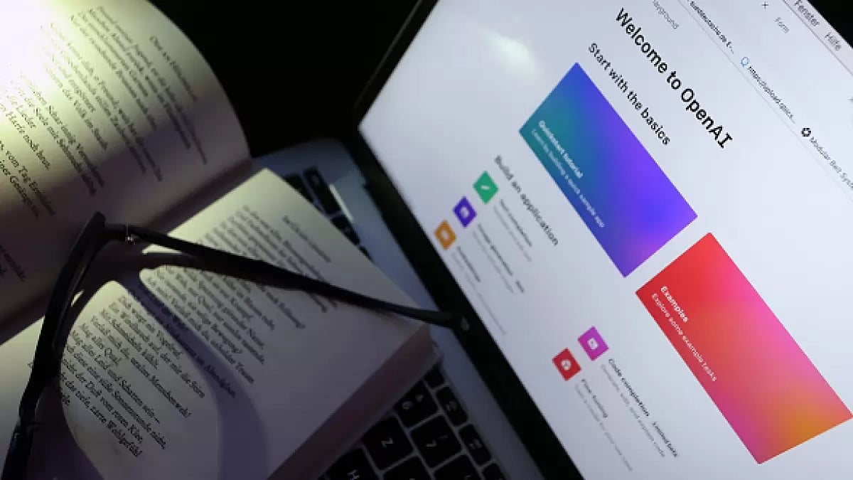 A book of poems lies on a screen on which the homepage of ChatGPT is called up.