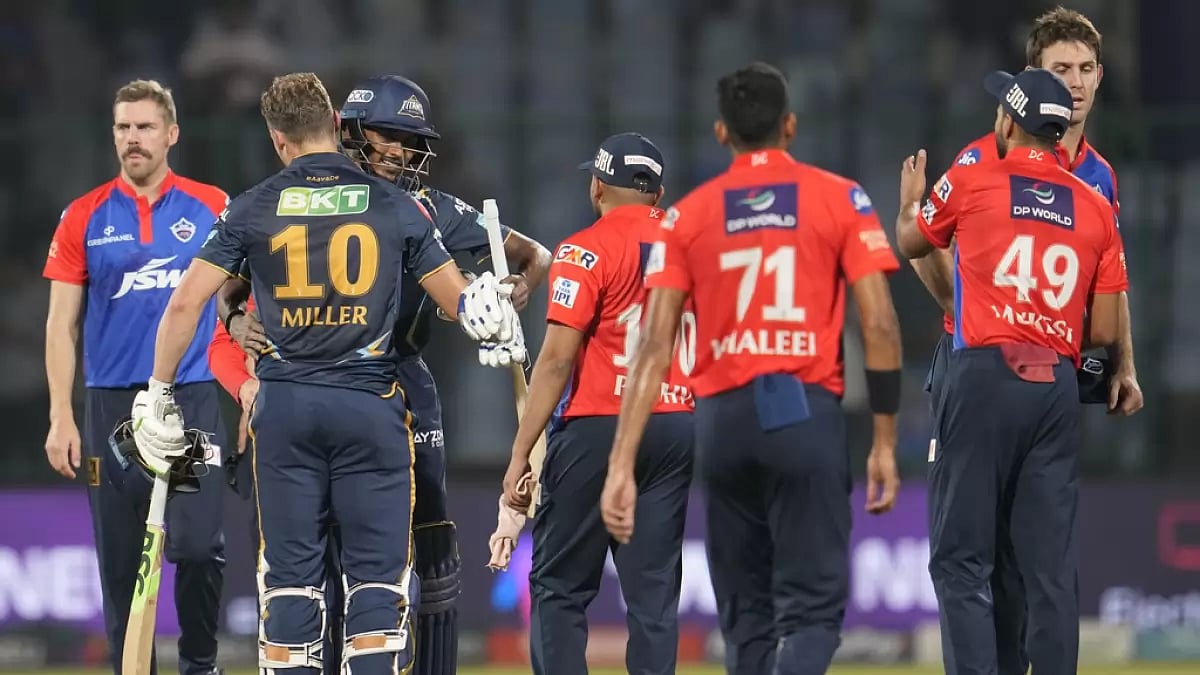 DC players exchange commiserations as GT batters celebrate their win on Tuesday.