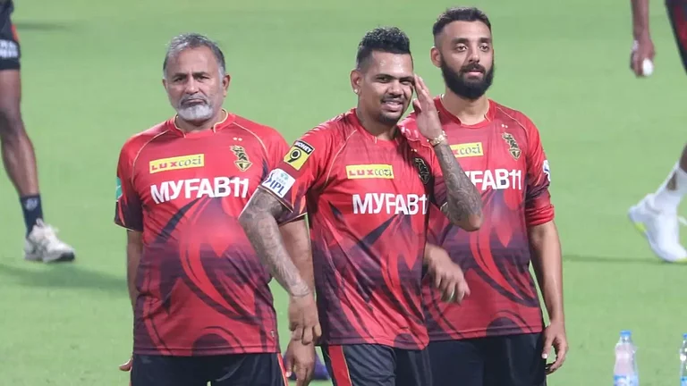 Bharat Arun, left, with Narine and Chakravarthy during a KKR practice session. - File
