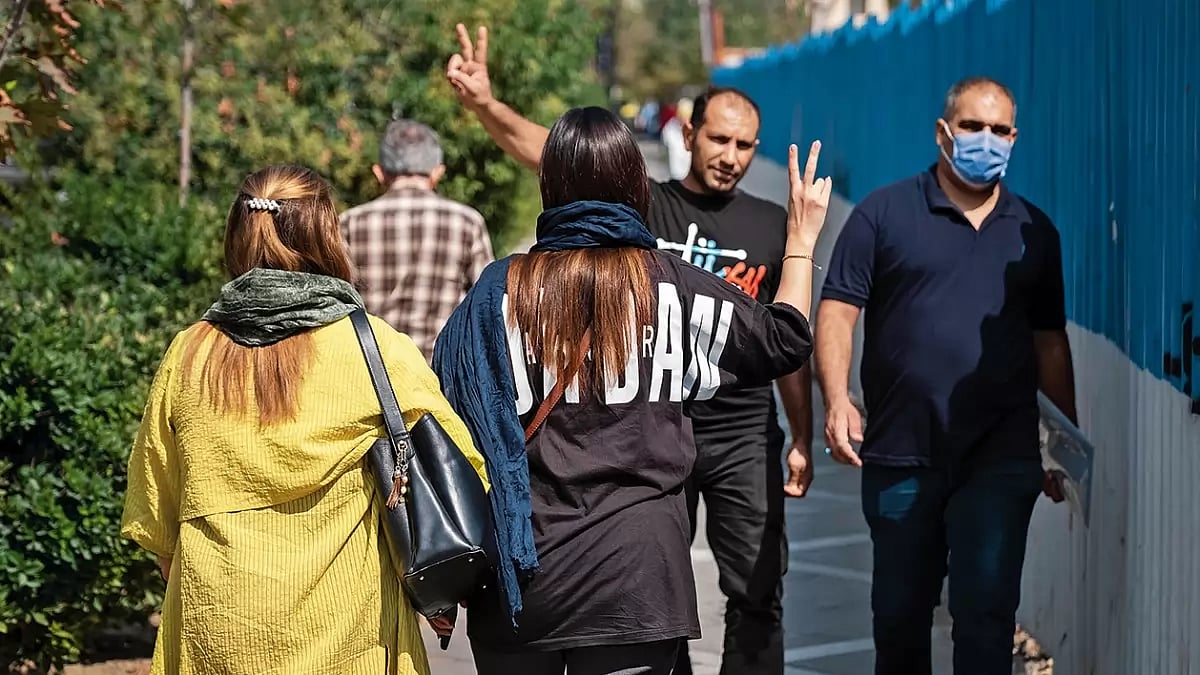 A Big Change: Women walk along a street in Tehran without wearing their headscarves 