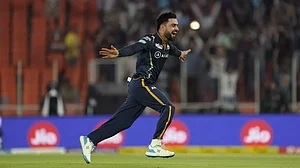 Rashid Khan celebrates his hat-trick by claiming the wicket of Shardul Thakur on Sunday.