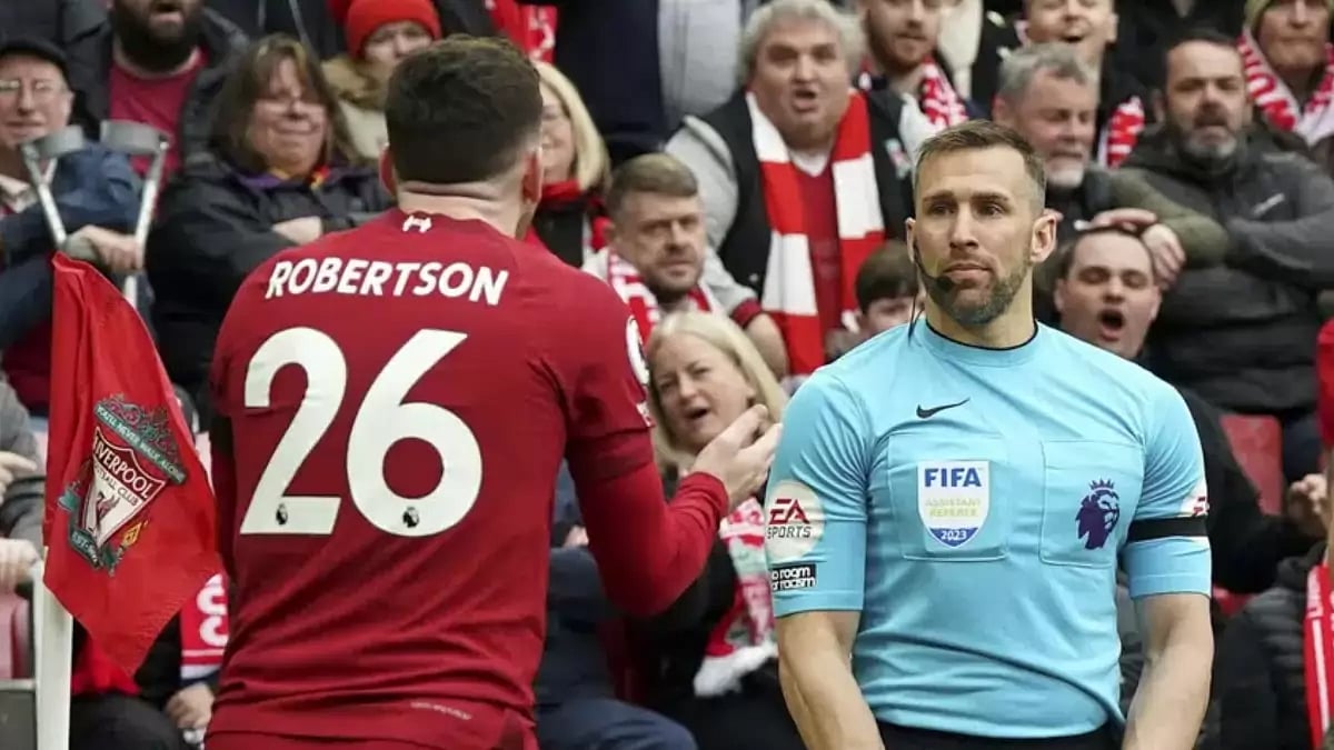Liverpool's Andrew Robertson and assistant referee Constantine Hatzidakis during their EPL match.