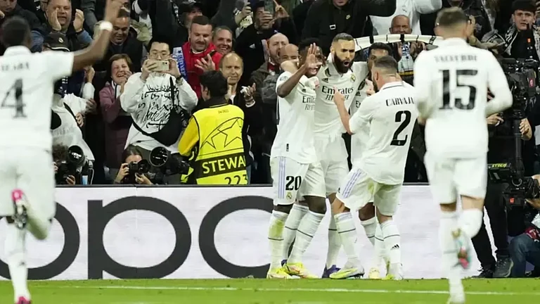 Real Madrid's Karim Benzema, right, celebrates with teammates after scoring the opening goal. - null