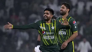 Pakistan's Babar Azam, center, Haris Rauf celebrate a wicket during the 1st T20I.