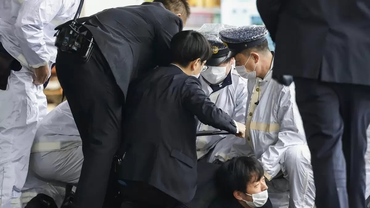 A man believed to be a suspect in the incident is caught by the police