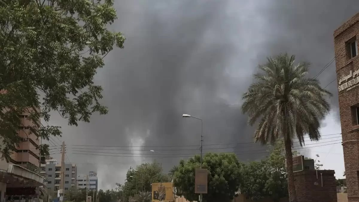 Smoke rising behind a building in Sudan.