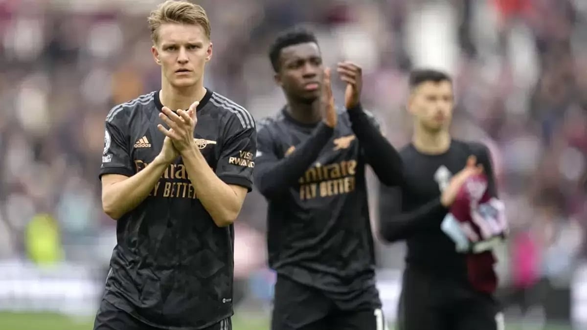 Martin Odegaard (L) applauds the away fans after the match between West Ham United vs Arsenal.