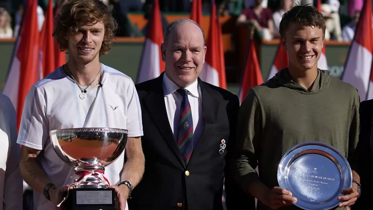 Andrey Rublev, left, and Holger Rune, of Denmark, pose with Prince Albert II of Monaco.