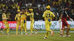 CSK players celebrate the dismissal of Maxwell in Bengaluru on Monday.