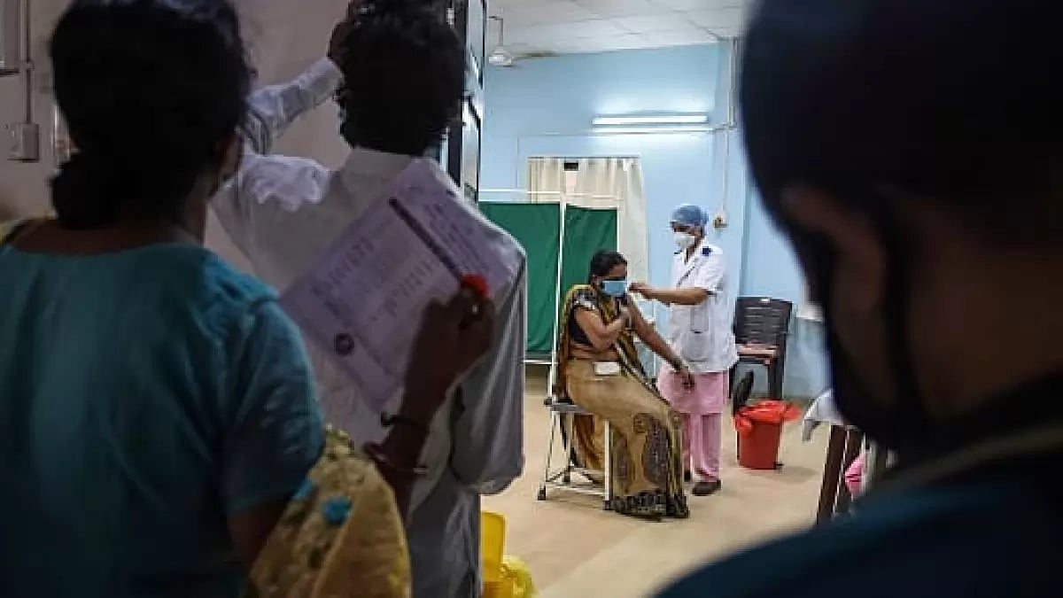 Woman receiving her Covid-19 vaccine at a mass vaccination center  in Mumbai,