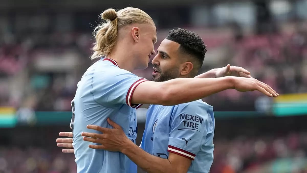 Mahrez, right, is congratulated by Haaland after his second goal against Sheffield on Saturday.