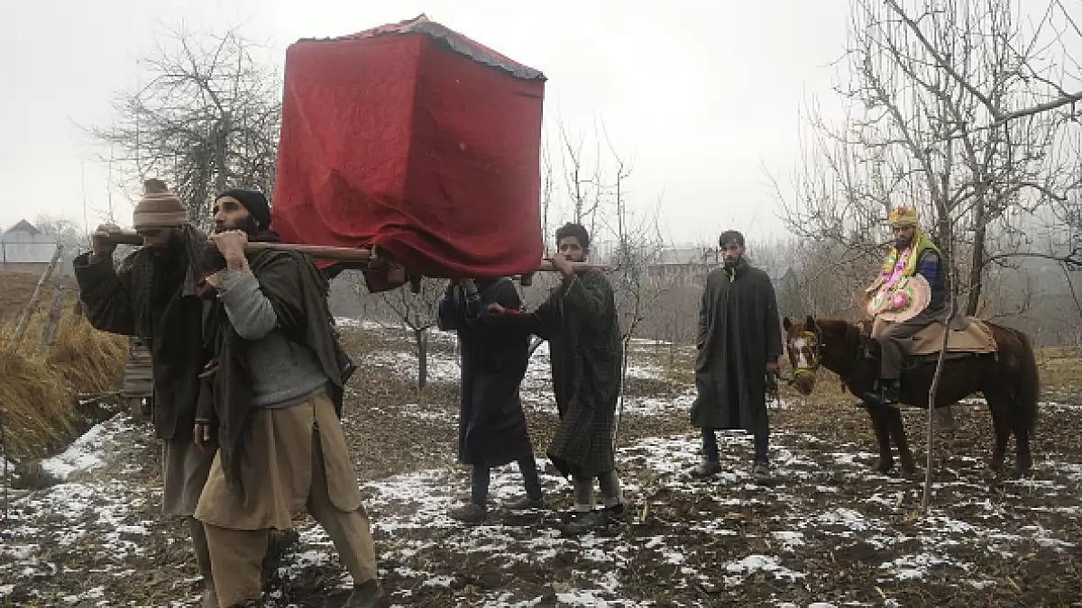  A Gujjar (nomad) marriage procession, with the groom on horse and the bride in a palanquin, at Sanger Wani village on December 13, 2018 in Pulwama, south of Srinagar, India. 