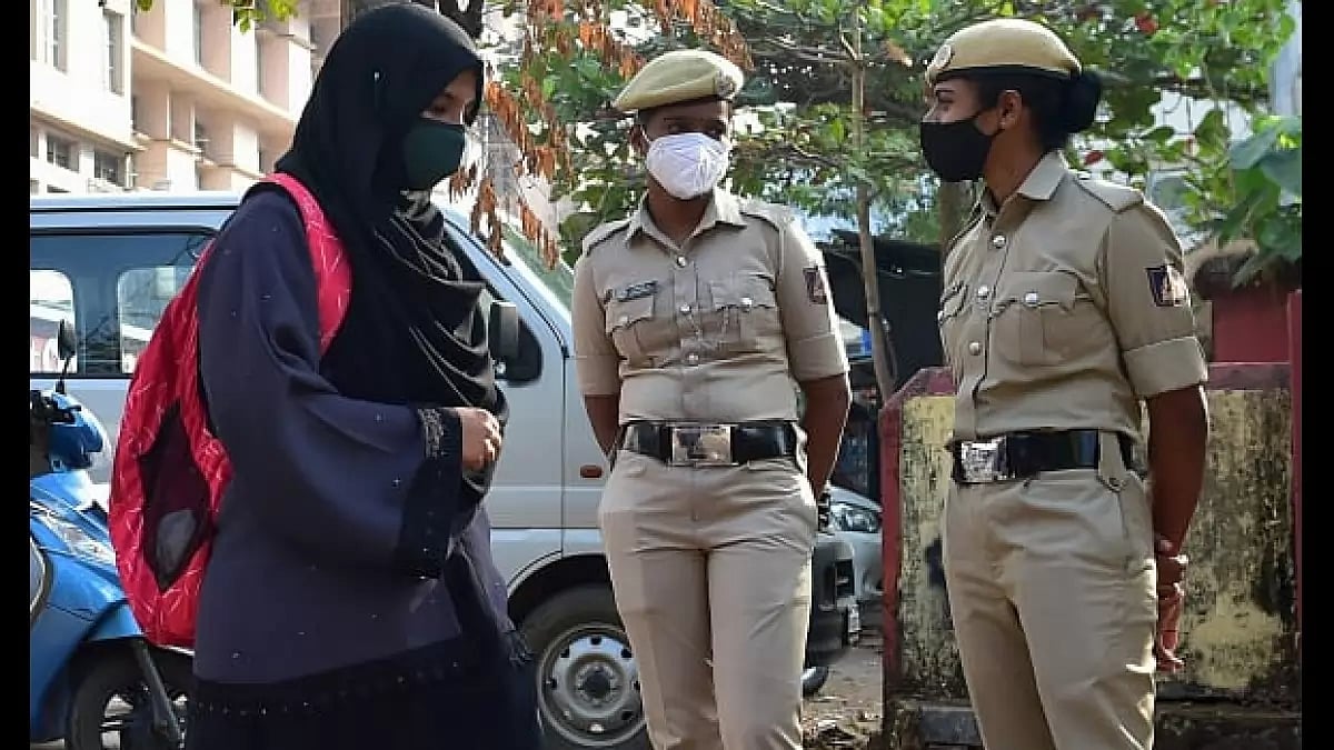 Hijab wearing schoolgirls arrive to attend their classes outside a govt school in Udupi