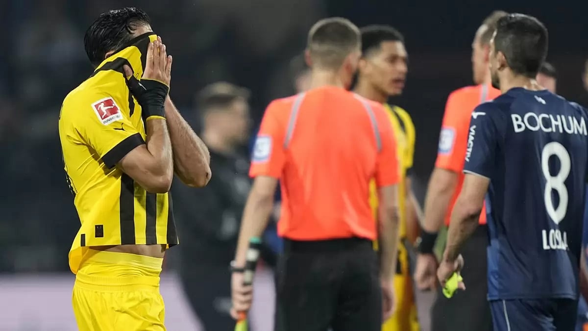 Emre Can covers his face after his team's draw against Bochum on Friday.