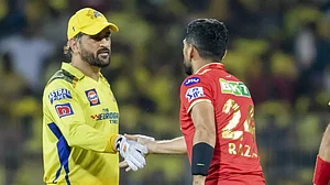 Dhoni congratulates Sikandar Raza on his team's victory in Chennai on Sunday.