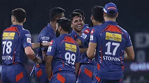 Bishnoi, centre, celebrates the wicket of Glenn Maxwell with his team-mates on Monday.
