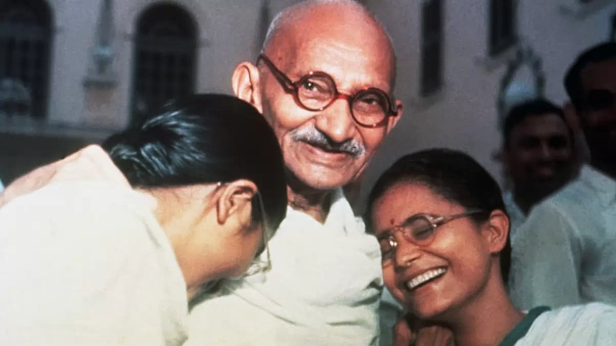 Mahatma Gandhi enjoys a laugh with his two granddaughters Ava and Manu at Birla House in New Delhi.