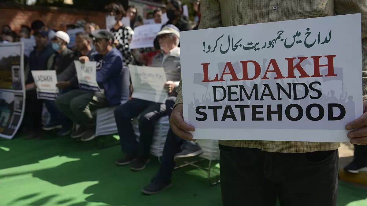 Protestors hold placards during a protest demanding statehood for the Ladakh region on February 15, 2023 in New Delhi, India