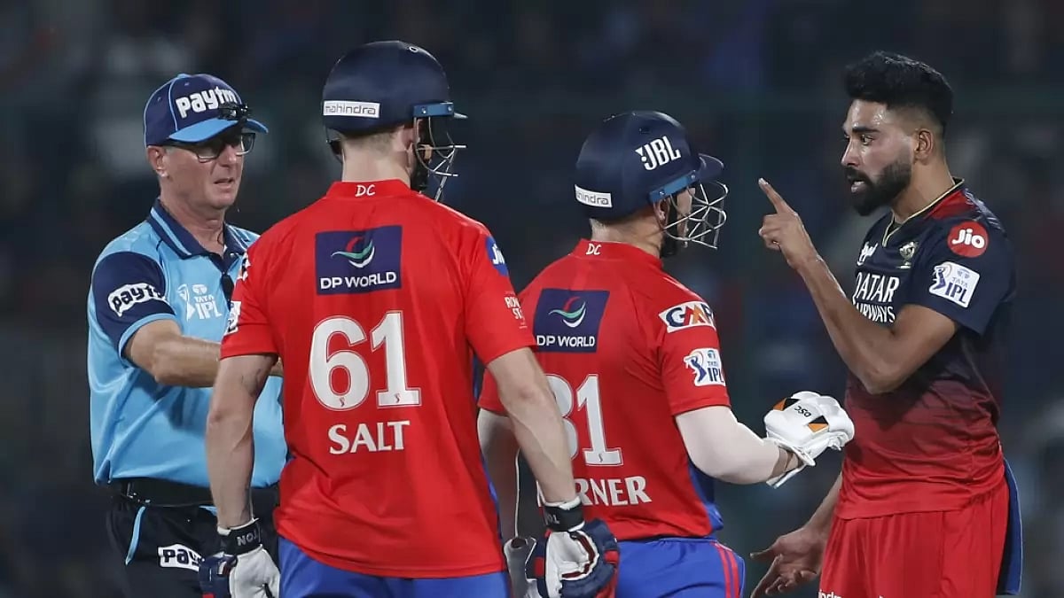 Warner, centre, tries to restore peace after Siraj engaged in an argument with Salt on Saturday.