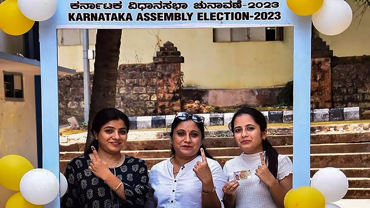 First-time voters pose for photographs at a selfie stand after casting votes for Karnataka Assembly polls, at a polling station, in Hubballi. (PTI Photo)