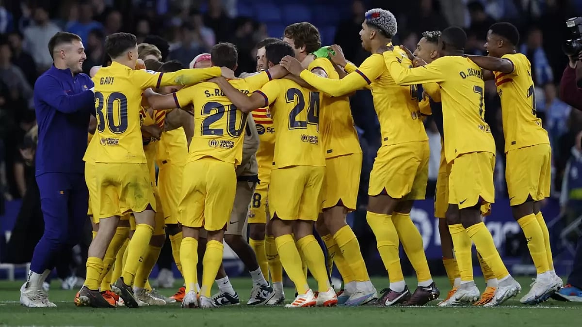 Barcelona players celebrate their title win after beating Espanyol on Sunday.