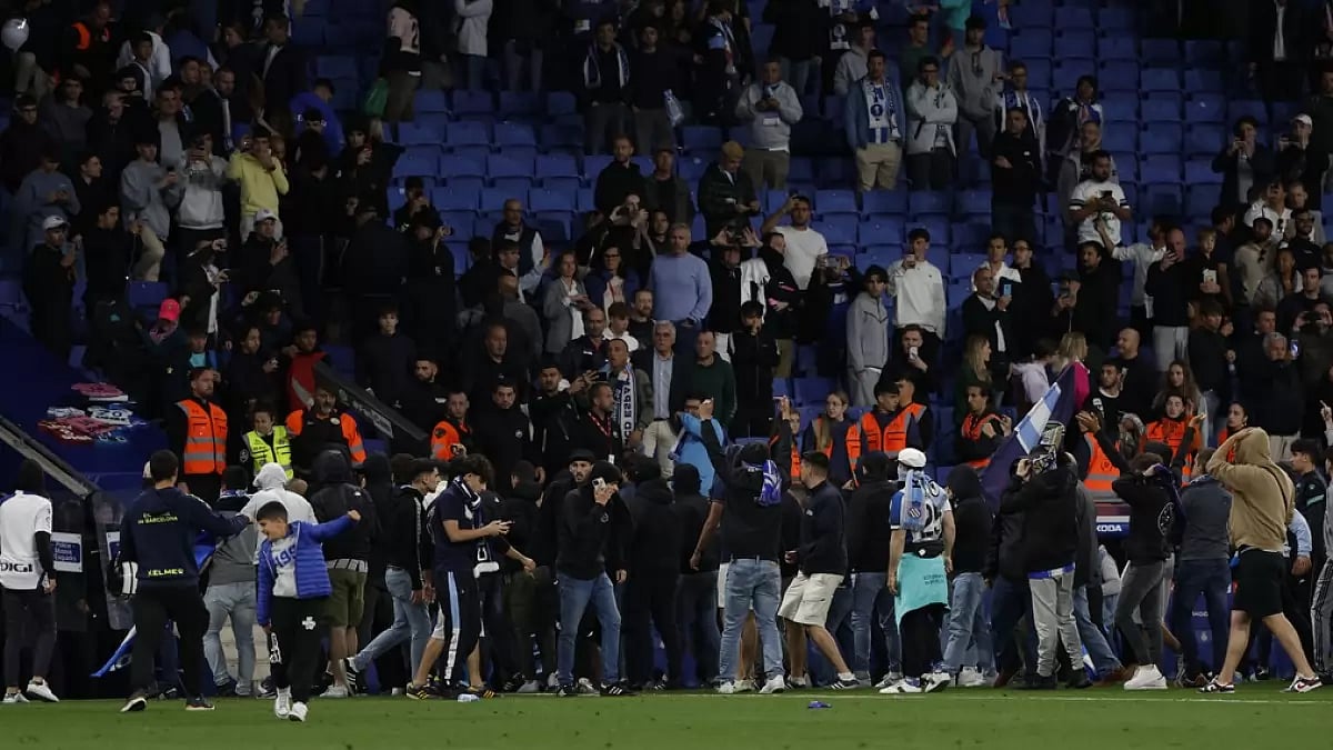 Fans invade the pitch after Barcelona's win over Espanyol on Sunday.