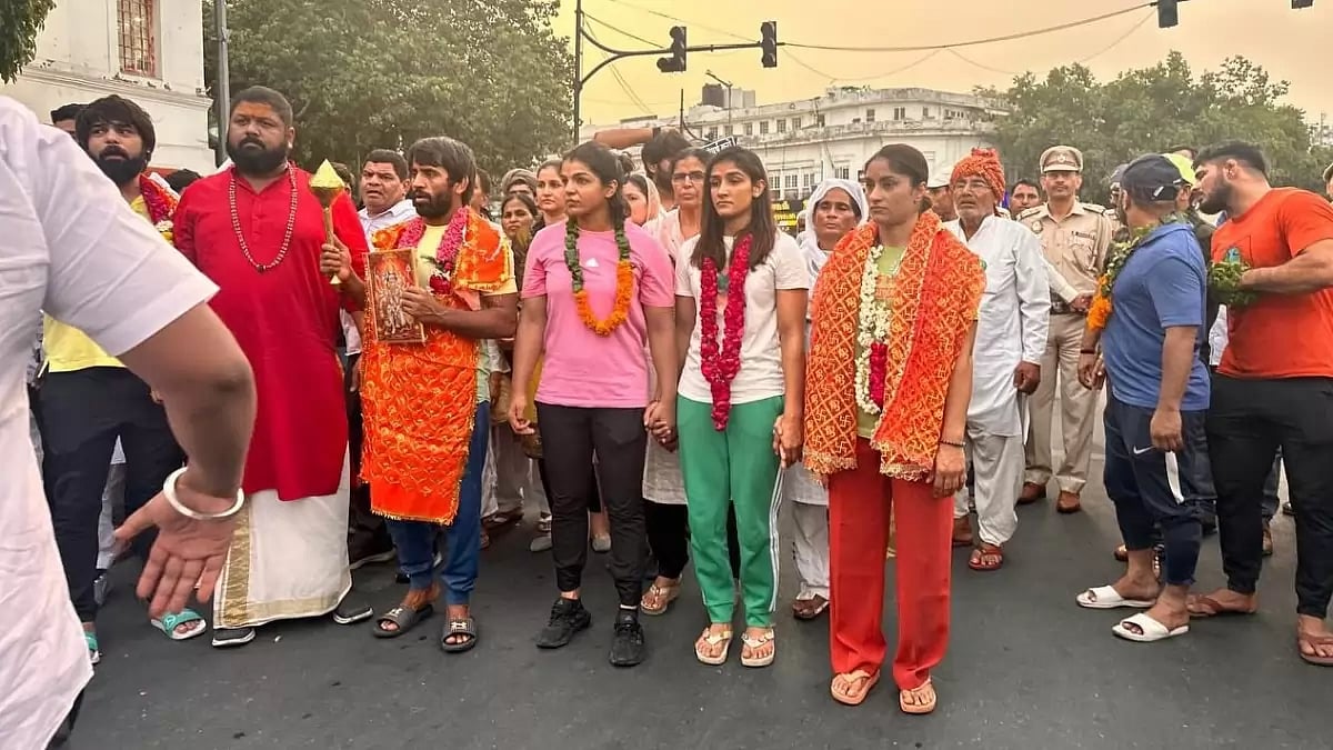 Many people marched alongside the wrestlers, carrying banners with slogans.