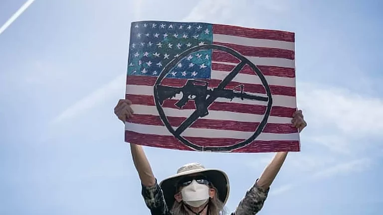 A protester holds up a sign during a rally against gun violence outside US Capitol. - null