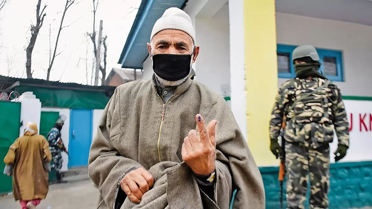 Getting Inked: An elderly person outside a voting booth during the District Development Council elec