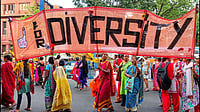 Women march with a banner preaching diversity.