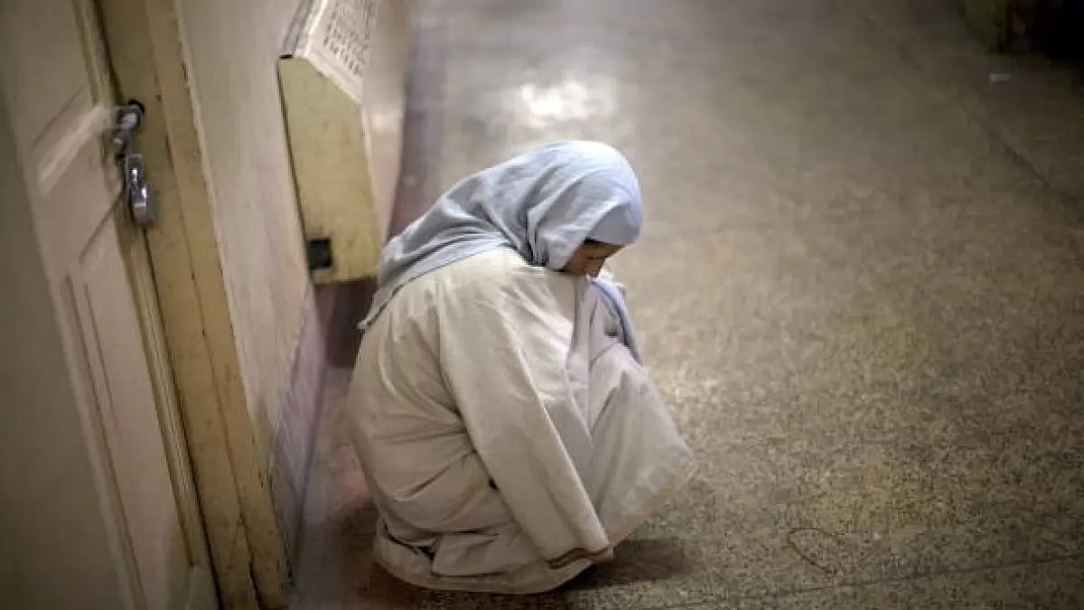 A Kashmiri widow whose husband was killed in a crossfire rests after being treated for trauma.