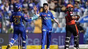 Madhwal, centre, celebrates the wicket of Vivrant Sharma in Mumbai on Sunday.