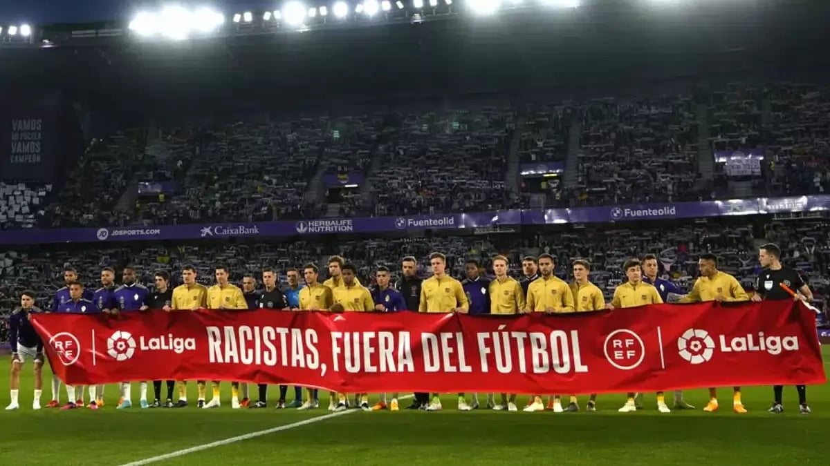 Players from Barcelona and Valladolid hold a banner before the match.