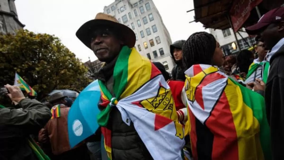 Man wearing Zimbabwe flag at a protest against Mugabe
