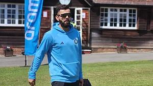Kohli arrives for the team practice session on Monday.
